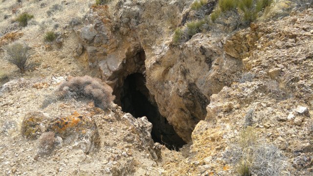 hole in ground (mine diggings or natural cave)